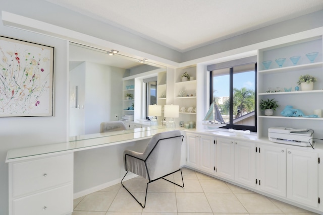 kitchen featuring white cabinets and light tile patterned flooring