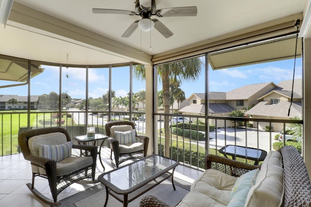 sunroom / solarium featuring ceiling fan