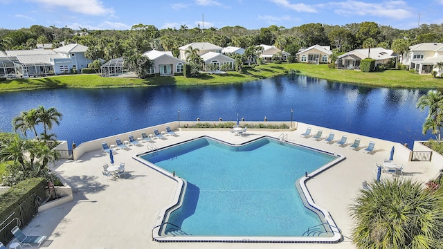 view of pool with a patio area and a water view