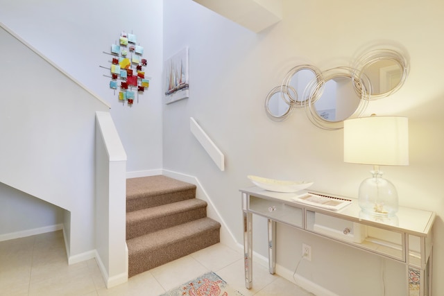 stairway featuring tile patterned flooring