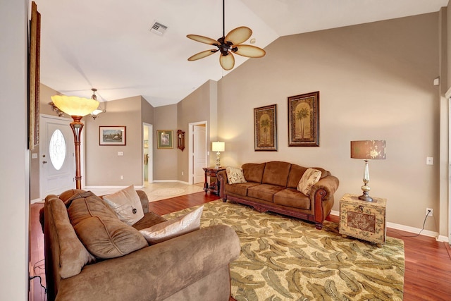 living room featuring visible vents, ceiling fan, vaulted ceiling, wood finished floors, and baseboards