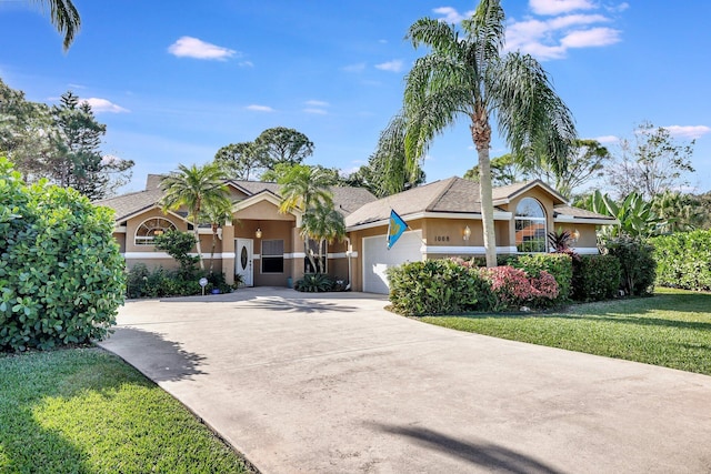 single story home with a garage and a front lawn