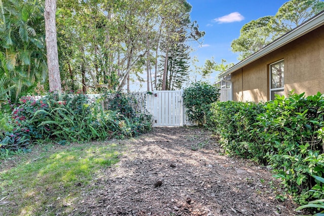 view of yard with fence and a gate