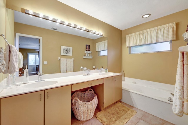 full bathroom with plenty of natural light, tile patterned flooring, and a sink