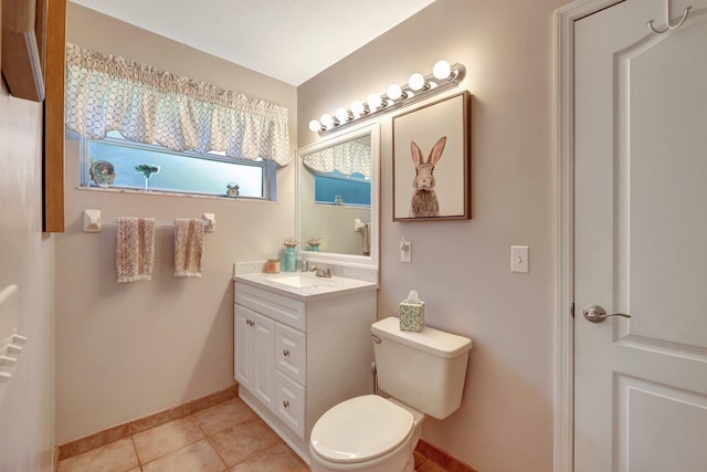 bathroom with baseboards, vanity, toilet, and tile patterned floors