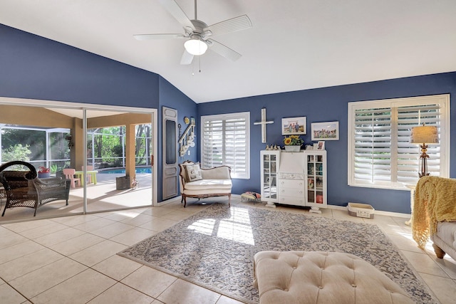 interior space with baseboards, vaulted ceiling, a ceiling fan, and tile patterned floors