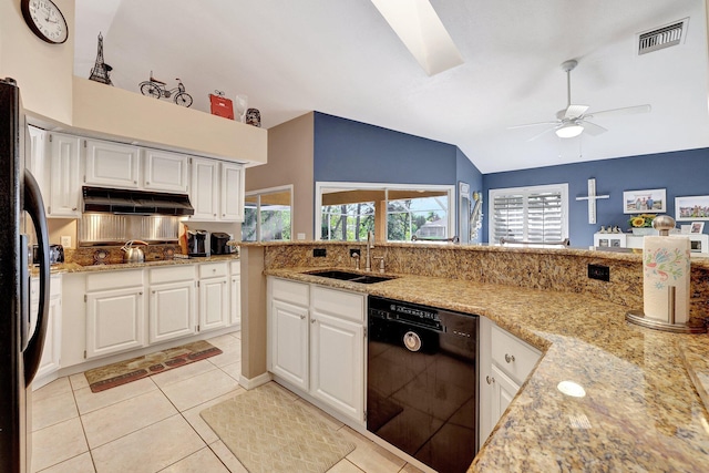 kitchen with under cabinet range hood, a sink, visible vents, vaulted ceiling, and black appliances