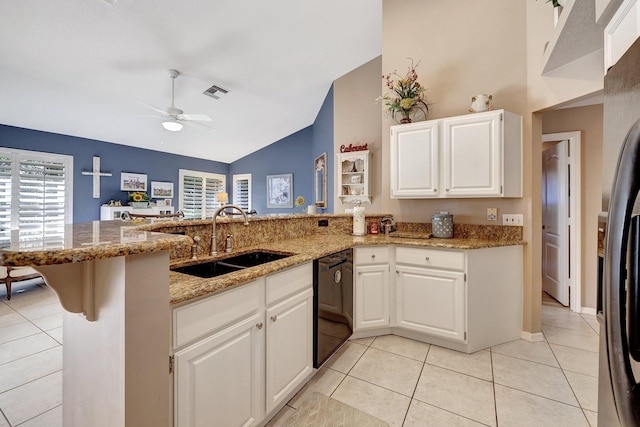 kitchen with light stone counters, visible vents, a sink, a peninsula, and black appliances