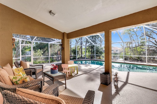 sunroom with lofted ceiling, visible vents, and a pool