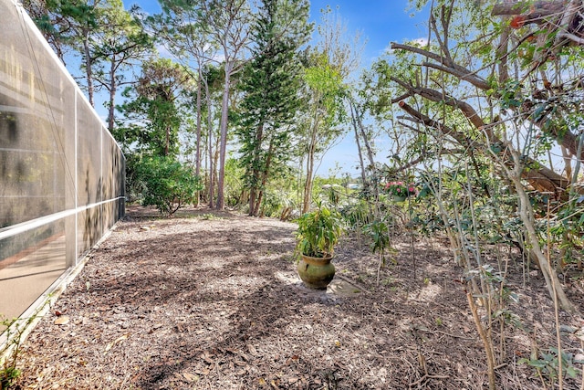 view of yard featuring glass enclosure