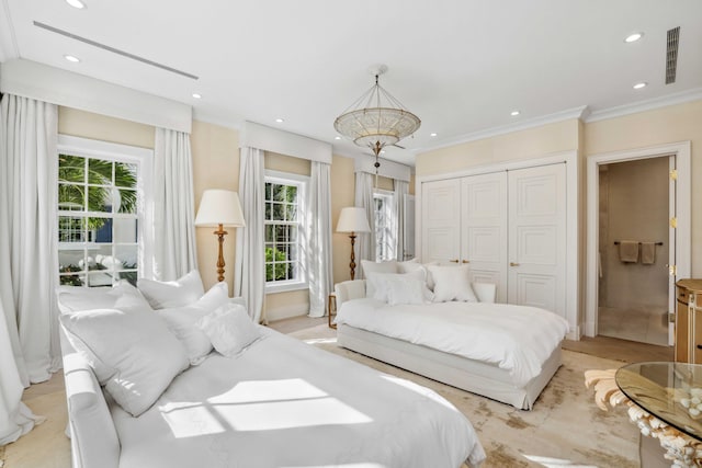 bedroom with multiple windows, a closet, and crown molding