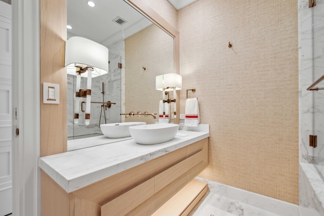 bathroom featuring a shower and vanity