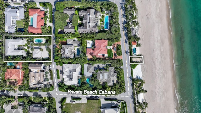 bird's eye view featuring a water view and a view of the beach