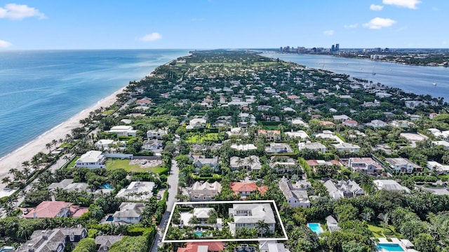 birds eye view of property featuring a water view and a view of the beach