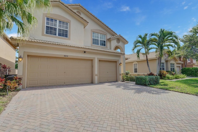 mediterranean / spanish-style home featuring a garage