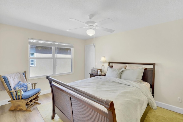 bedroom with ceiling fan and light wood-type flooring