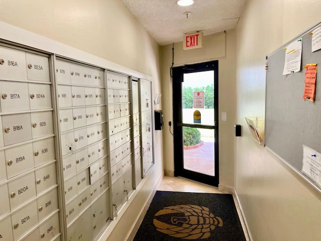 entryway with a textured ceiling and mail boxes