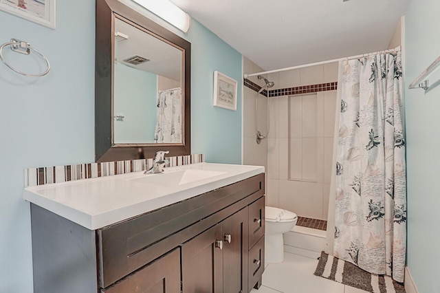 bathroom with tile patterned flooring, vanity, toilet, and walk in shower