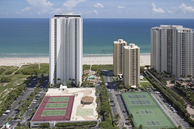 birds eye view of property featuring a water view and a beach view