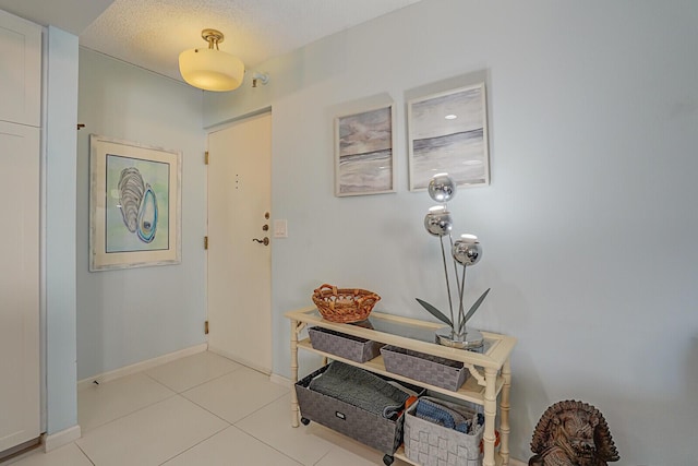 foyer entrance with light tile patterned floors