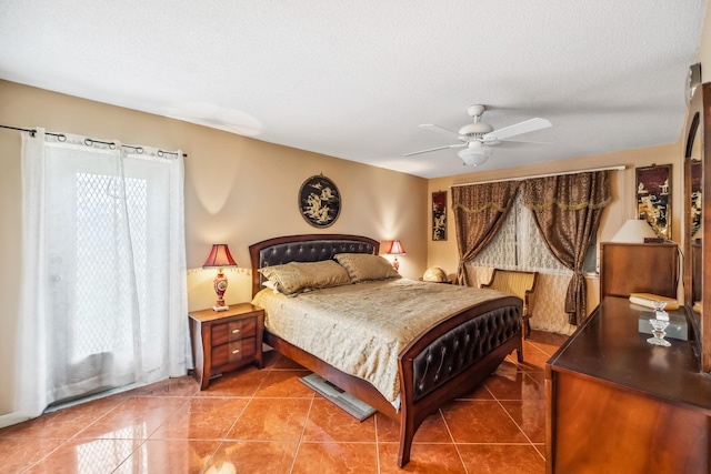 tiled bedroom with a textured ceiling and ceiling fan