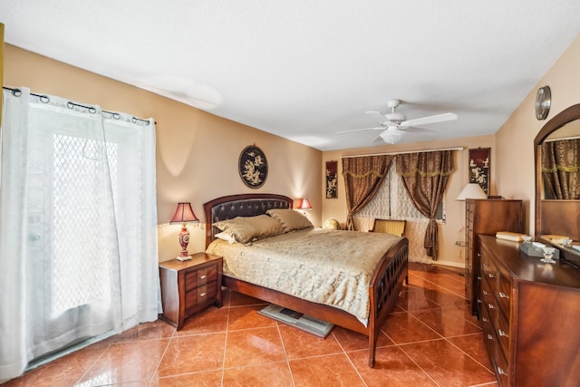 tiled bedroom featuring ceiling fan