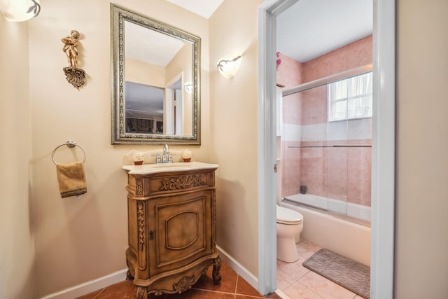 full bathroom featuring shower / bath combination with glass door, vanity, tile patterned floors, and toilet