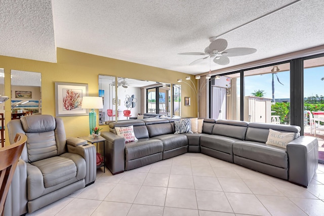 tiled living room with a textured ceiling, ceiling fan, and a wealth of natural light