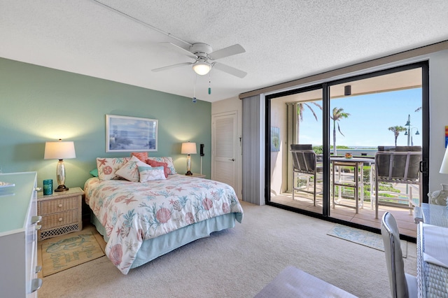 bedroom with a textured ceiling, access to outside, light carpet, ceiling fan, and a closet