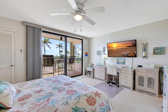 bedroom with ceiling fan, a closet, a textured ceiling, and access to exterior