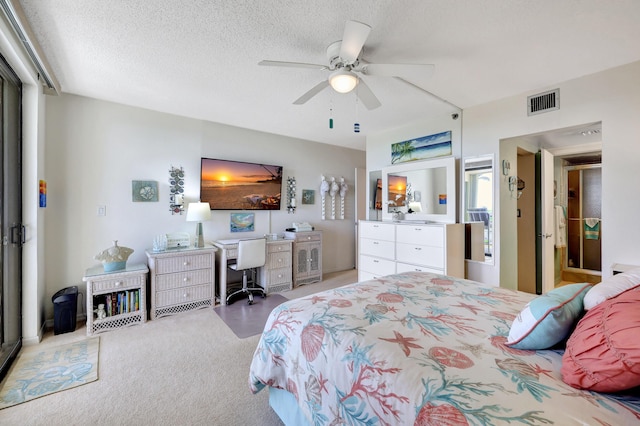 bedroom featuring a textured ceiling, ceiling fan, and carpet floors