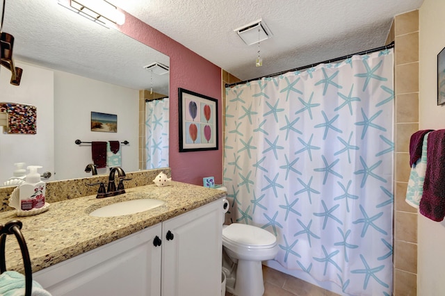 bathroom featuring toilet, a textured ceiling, walk in shower, tile patterned flooring, and vanity