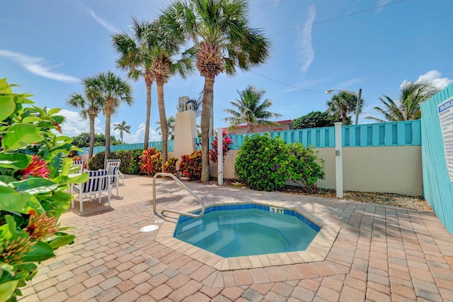 view of swimming pool with a patio area and a hot tub