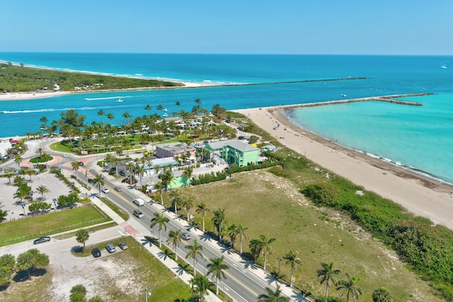 birds eye view of property with a water view and a view of the beach