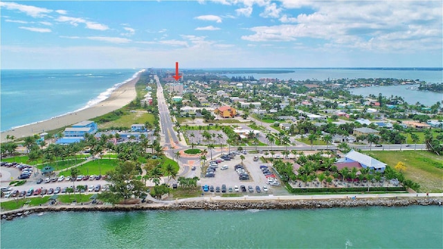 birds eye view of property featuring a view of the beach and a water view