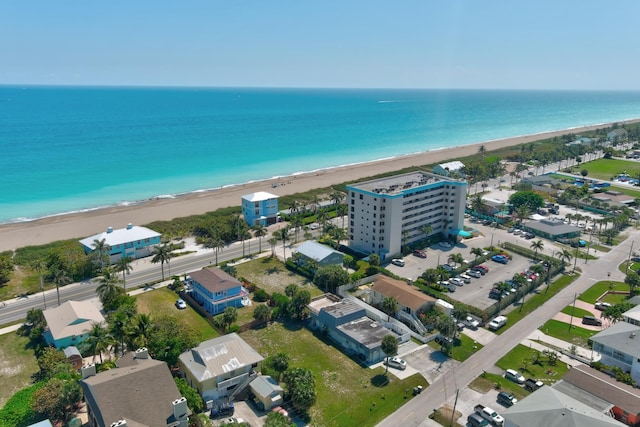 birds eye view of property with a water view and a view of the beach