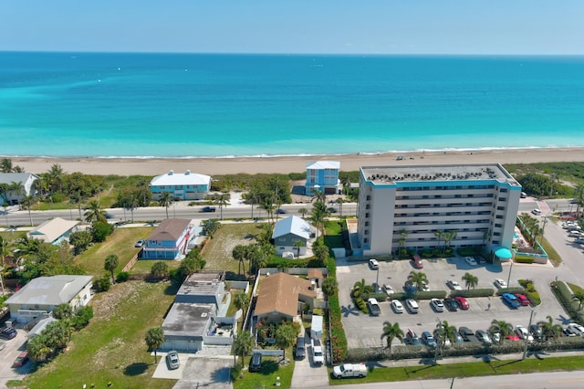 birds eye view of property featuring a beach view and a water view