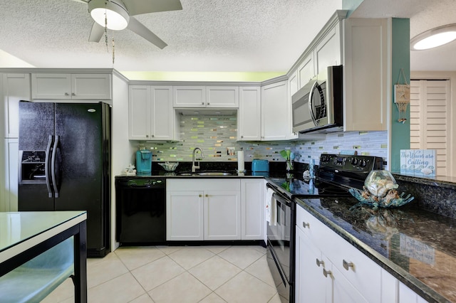 kitchen featuring light tile patterned floors, white cabinetry, black appliances, and sink