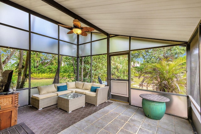 unfurnished sunroom featuring lofted ceiling with beams and ceiling fan