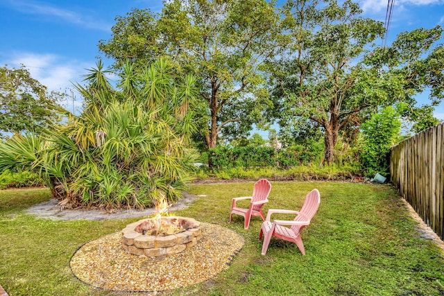 view of yard with a fire pit