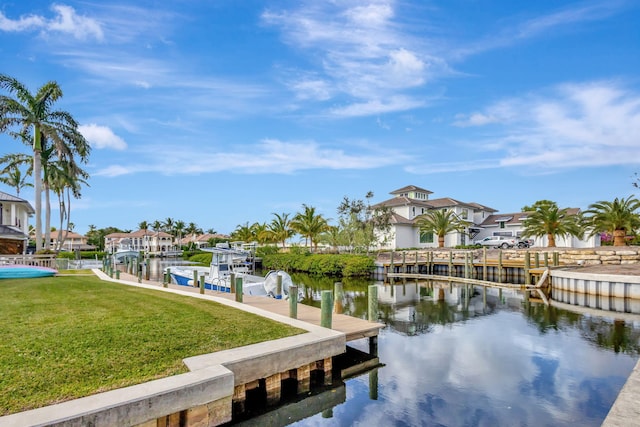 dock area with a lawn and a water view