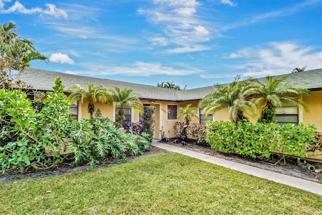 ranch-style home with a front lawn