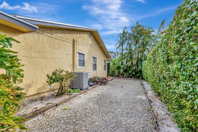 view of property exterior featuring central AC and a patio