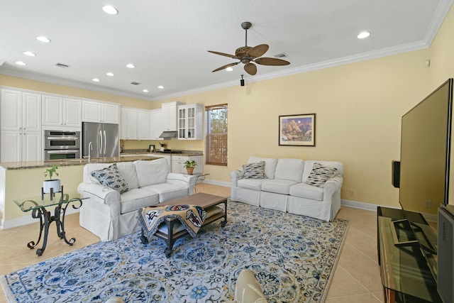 tiled living room featuring ceiling fan and crown molding