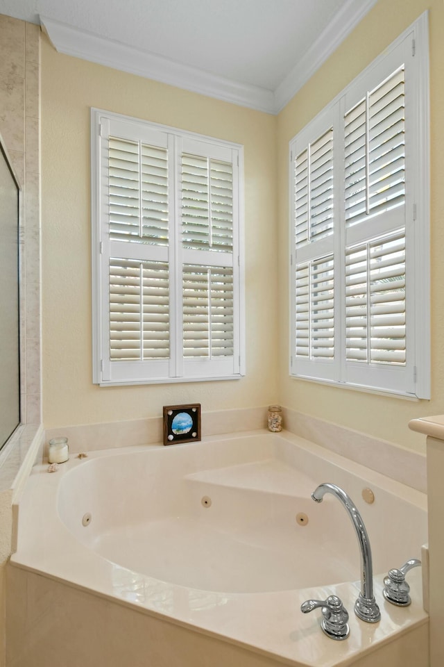 bathroom with a tub to relax in and crown molding