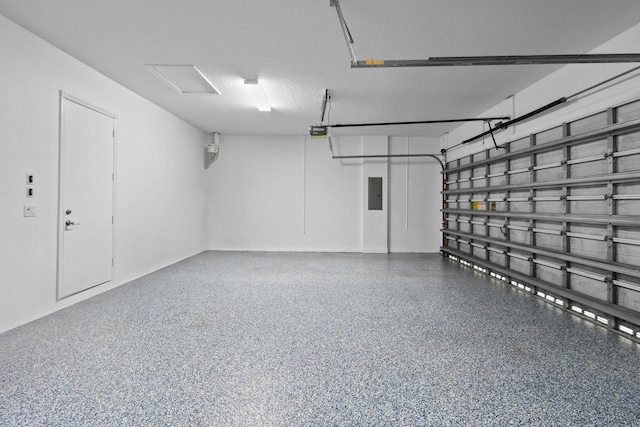 garage with a garage door opener and electric panel