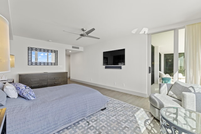 bedroom with ceiling fan and light hardwood / wood-style floors