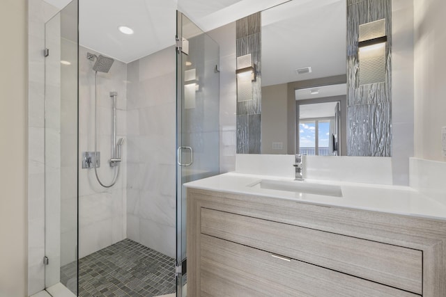 bathroom with an enclosed shower and vanity