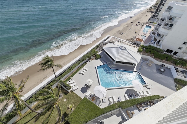 drone / aerial view featuring a water view and a view of the beach