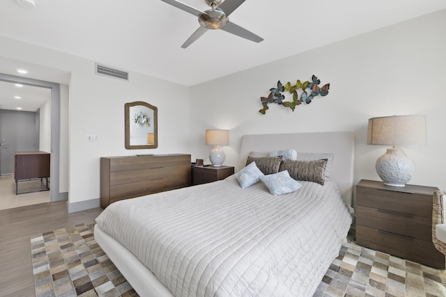 bedroom with ceiling fan and light hardwood / wood-style floors